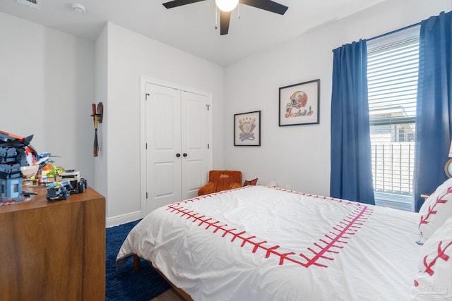 bedroom featuring a ceiling fan, a closet, visible vents, and baseboards