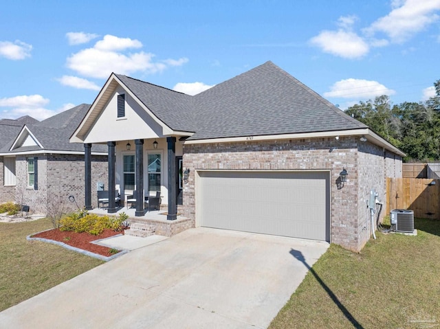 view of front facade featuring central air condition unit, a shingled roof, a garage, and a front yard