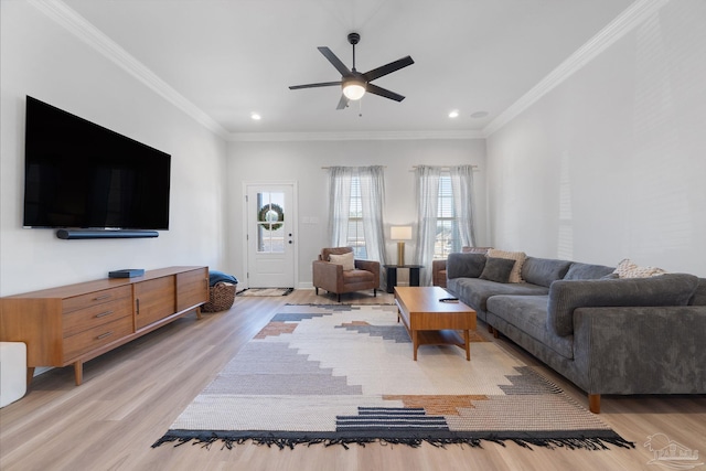 living area with light wood-style floors, plenty of natural light, and crown molding