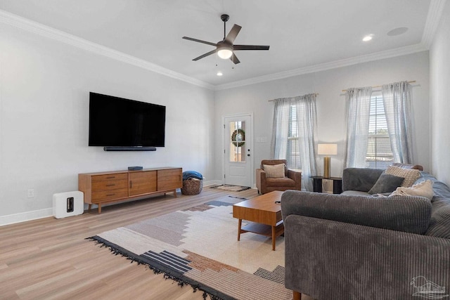 living area featuring recessed lighting, ornamental molding, ceiling fan, light wood-type flooring, and baseboards