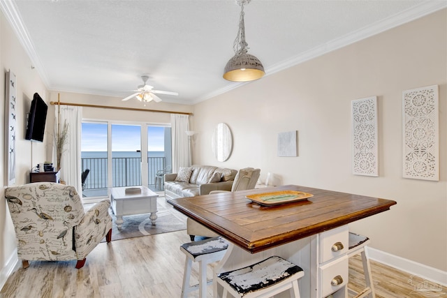 401 E Beach Blvd Unit 1207, Gulf Shores, AL 36542 - dining area with a ceiling fan, light wood finished floors, ornamental molding, and baseboards