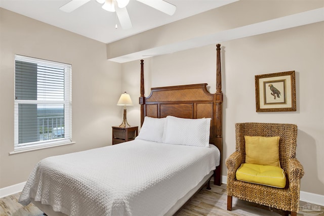 401 E Beach Blvd Unit 1207, Gulf Shores, AL 36542 - bedroom with baseboards, light wood-type flooring, and a ceiling fan