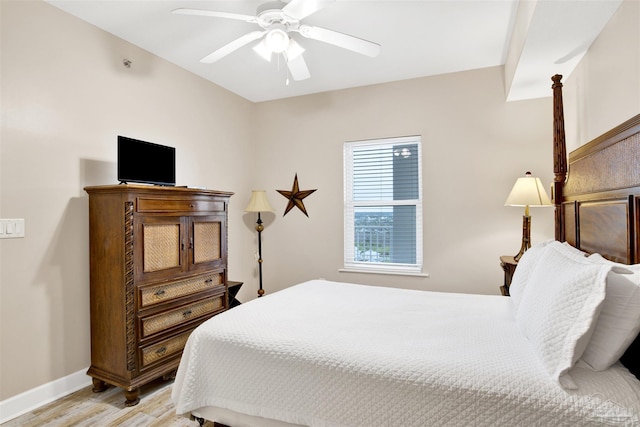 401 E Beach Blvd Unit 1207, Gulf Shores, AL 36542 - bedroom with light wood finished floors, baseboards, and a ceiling fan