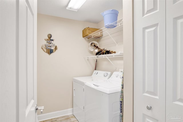 401 E Beach Blvd Unit 1207, Gulf Shores, AL 36542 - laundry room with washing machine and clothes dryer and baseboards