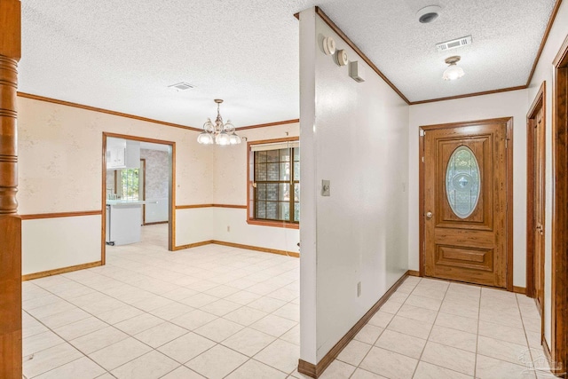 entrance foyer featuring crown molding, light tile patterned floors, a textured ceiling, and a notable chandelier