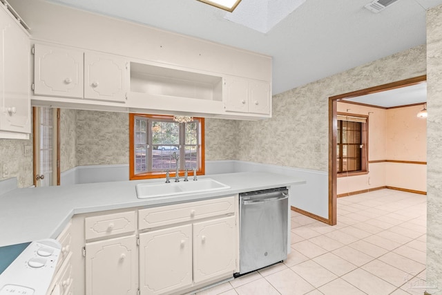 kitchen with sink, light tile patterned floors, crown molding, dishwasher, and white cabinetry