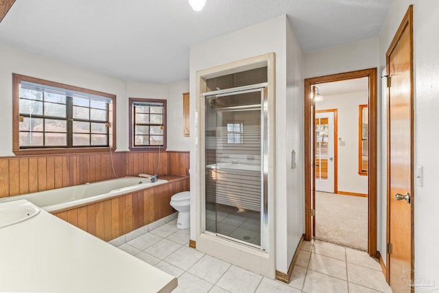 full bathroom with tile patterned flooring, vanity, shower with separate bathtub, and toilet