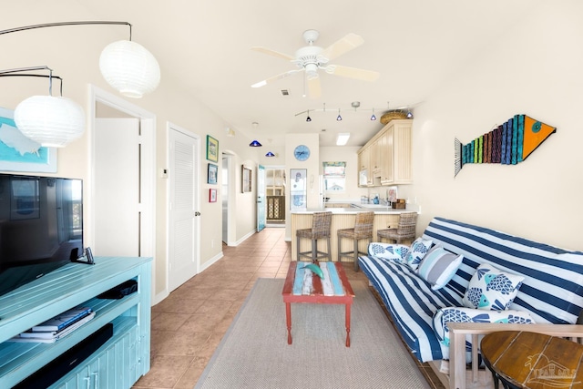 living room featuring ceiling fan and light tile patterned floors