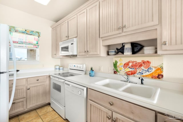 kitchen featuring sink, white appliances, light brown cabinets, and light tile patterned floors