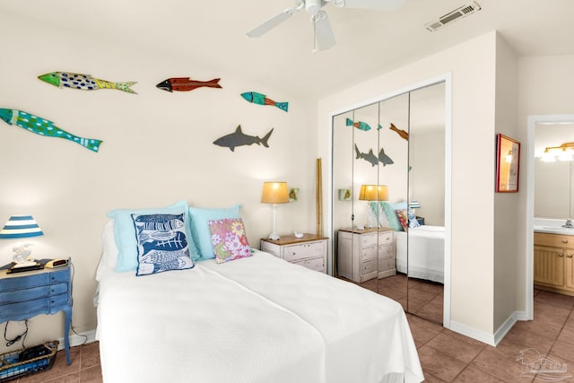 bedroom featuring a closet, ensuite bath, ceiling fan, light tile patterned floors, and sink