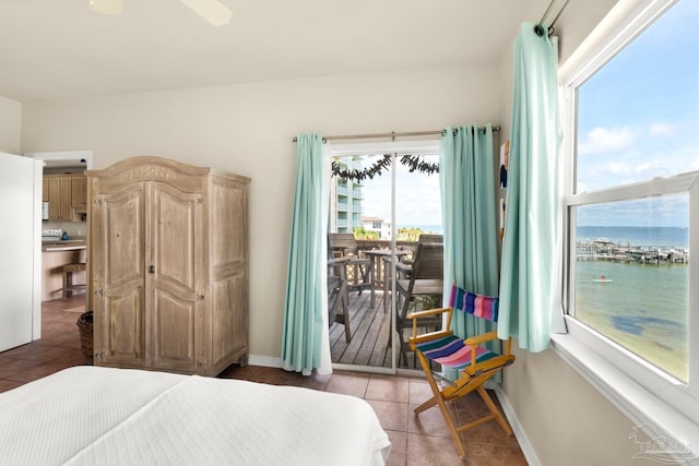 tiled bedroom featuring a water view, ceiling fan, and access to outside