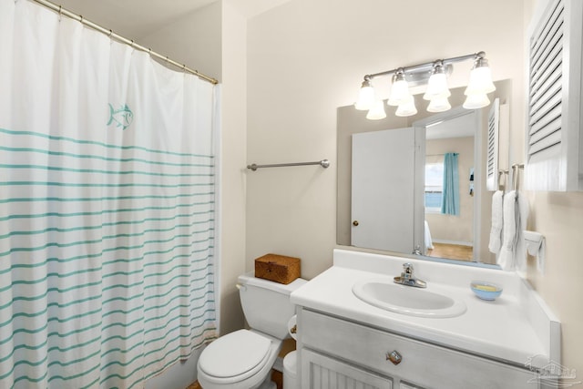 bathroom featuring vanity, toilet, and walk in shower