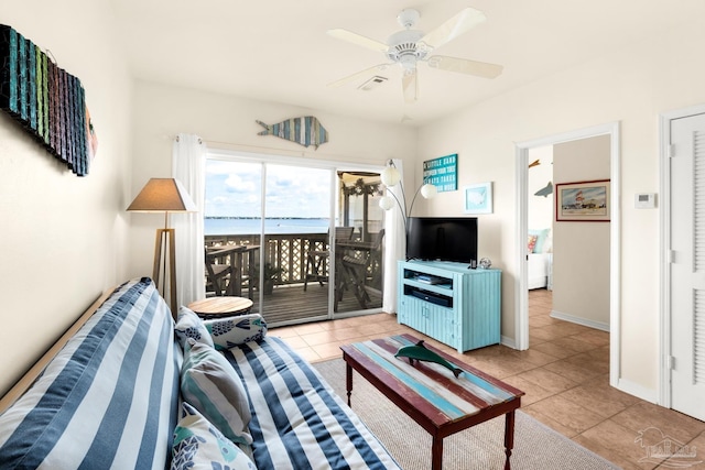 living room featuring light tile patterned floors and ceiling fan