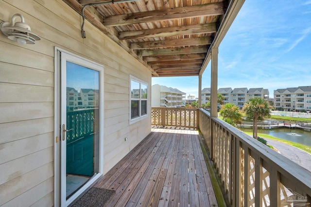 wooden terrace featuring a water view