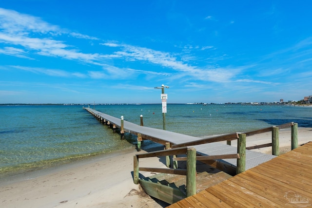 view of dock with a water view and a view of the beach