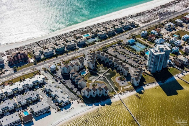 drone / aerial view featuring a water view and a beach view