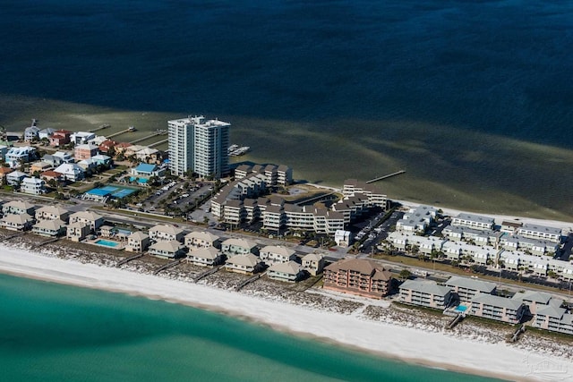 birds eye view of property with a water view and a beach view