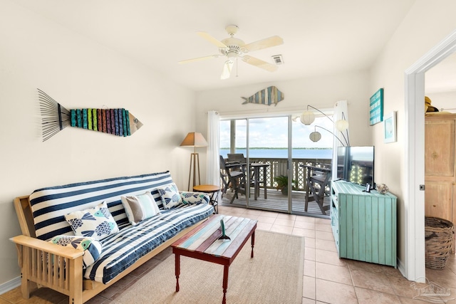 tiled living room featuring ceiling fan