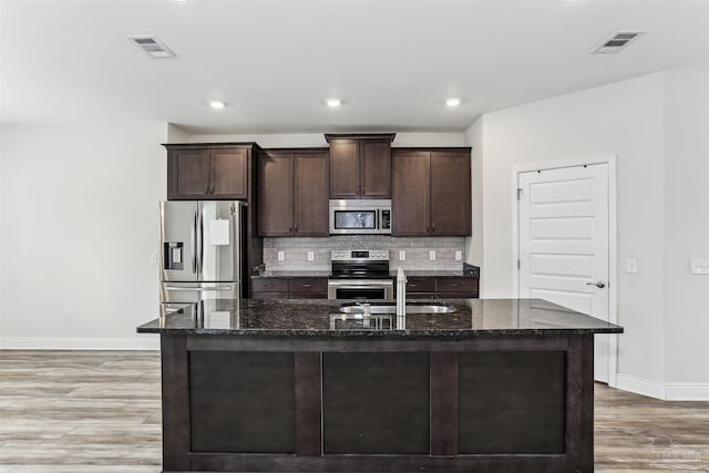 415 Broadleaf Cir, Cantonment, FL 32533 - kitchen with appliances with stainless steel finishes, baseboards, light wood-style flooring, dark brown cabinets, and recessed lighting