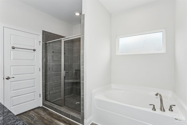 415 Broadleaf Cir, Cantonment, FL 32533 - bathroom featuring a bath, a shower stall, and wood finished floors