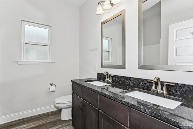 415 Broadleaf Cir, Cantonment, FL 32533 - bathroom featuring baseboards, double vanity, toilet, and wood finished floors