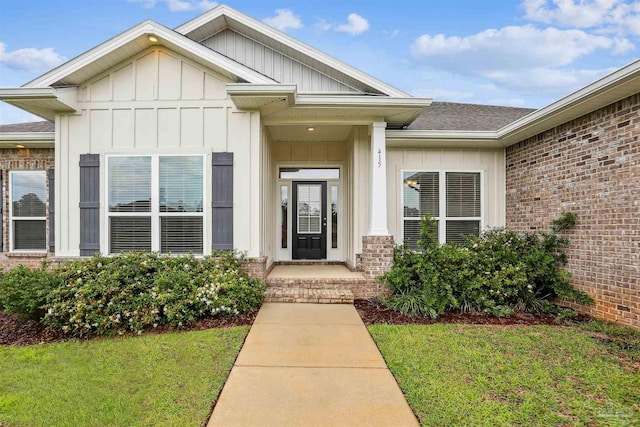 415 Broadleaf Cir, Cantonment, FL 32533 - entrance to property with board and batten siding, a yard, and brick siding