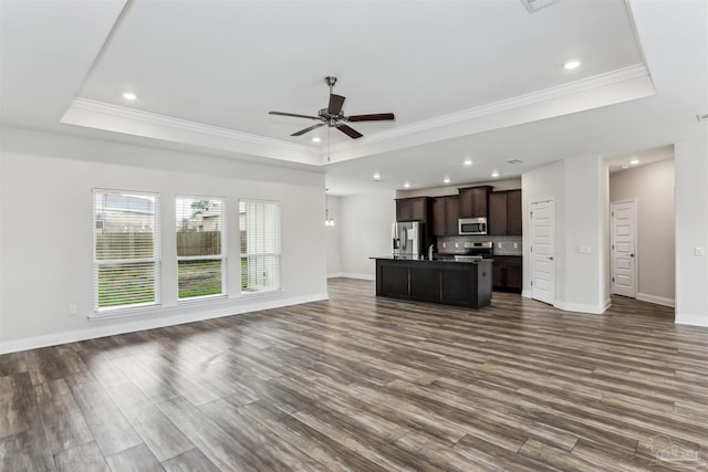 415 Broadleaf Cir, Cantonment, FL 32533 - unfurnished living room with a tray ceiling, ceiling fan, dark wood finished floors, recessed lighting, and baseboards