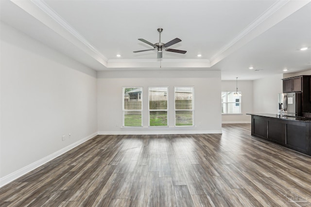 415 Broadleaf Cir, Cantonment, FL 32533 - unfurnished living room with a tray ceiling, a ceiling fan, baseboards, dark wood-style flooring, and ornamental molding