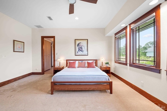 bedroom featuring ceiling fan and light carpet