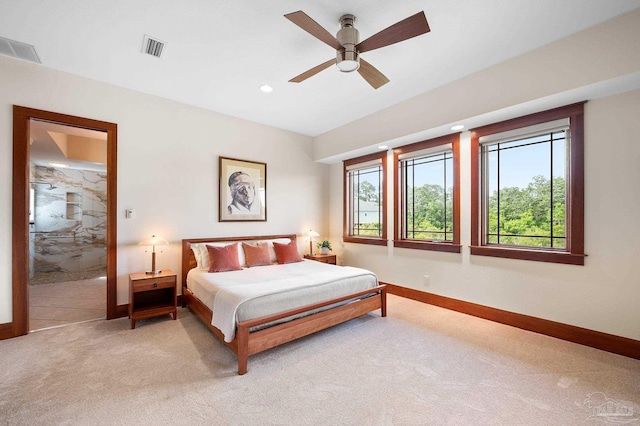 bedroom with ceiling fan and light carpet