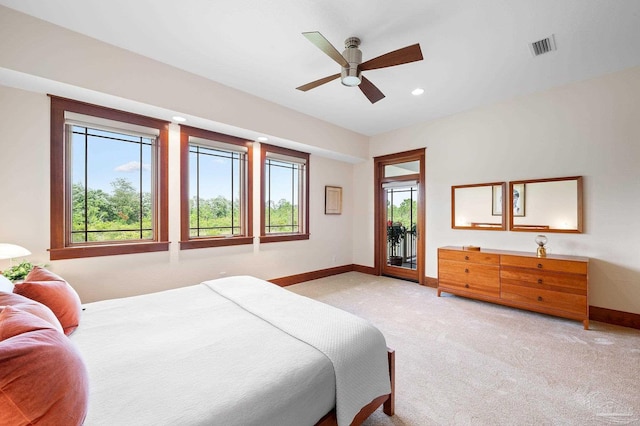 bedroom with light carpet, ceiling fan, and access to exterior