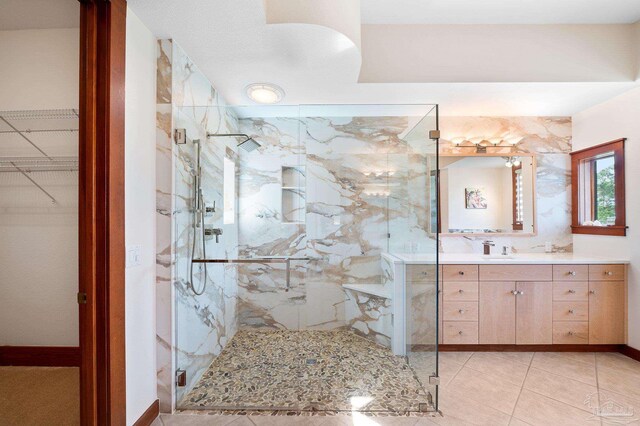 bathroom with vanity, tile patterned flooring, and a shower with door