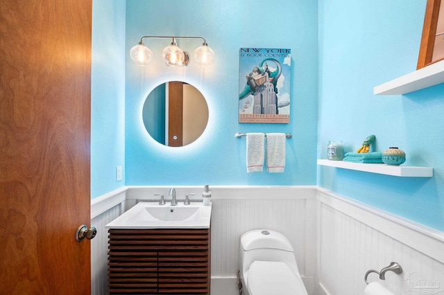 bathroom featuring vanity and toilet