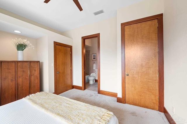 bedroom with connected bathroom, ceiling fan, and light colored carpet