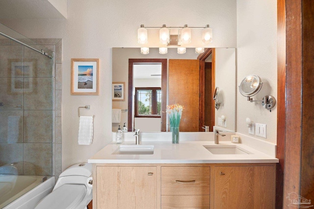 full bathroom with vanity, enclosed tub / shower combo, and toilet