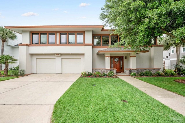 view of front of property featuring a garage and a front lawn