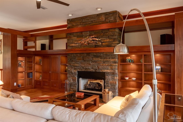 living room with ceiling fan, a fireplace, and hardwood / wood-style floors