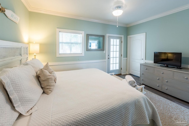 bedroom featuring multiple windows, ornamental molding, and light hardwood / wood-style flooring