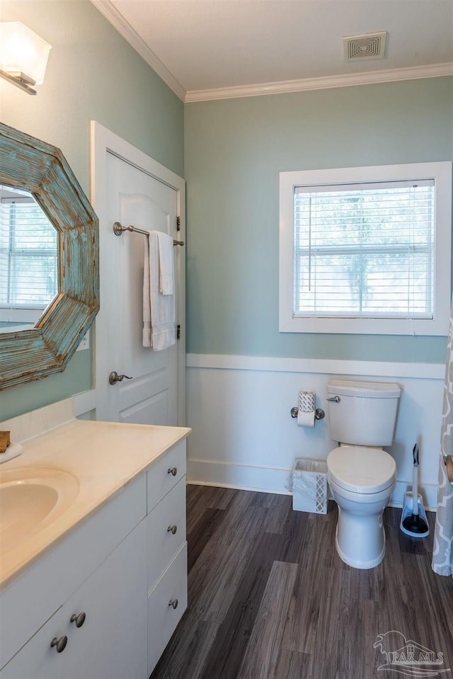 bathroom with vanity, hardwood / wood-style floors, toilet, and crown molding