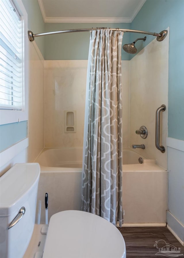 bathroom with ornamental molding, toilet, shower / bath combo with shower curtain, and hardwood / wood-style flooring