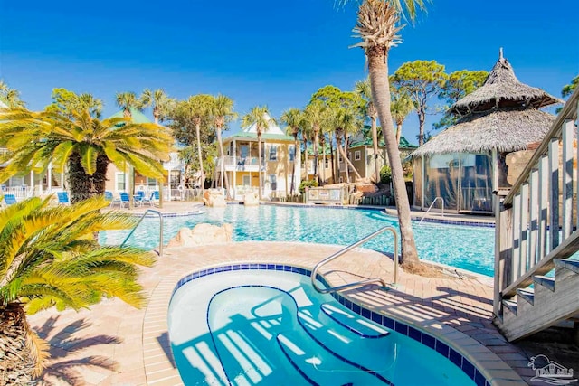 view of swimming pool featuring a community hot tub