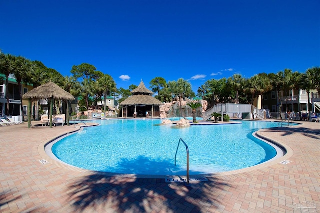 view of swimming pool featuring a patio and a gazebo