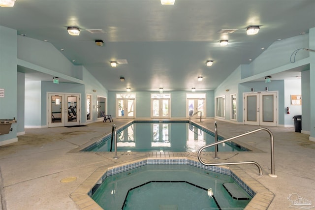 view of pool with french doors and an indoor hot tub