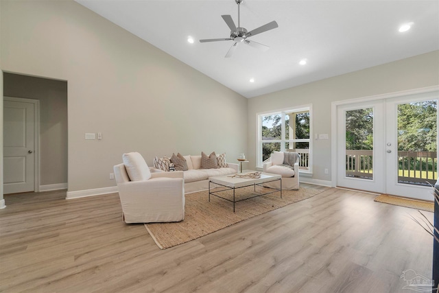 living room featuring light wood-type flooring, french doors, high vaulted ceiling, and ceiling fan