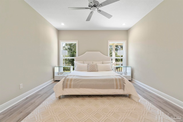 bedroom featuring ceiling fan and light hardwood / wood-style flooring