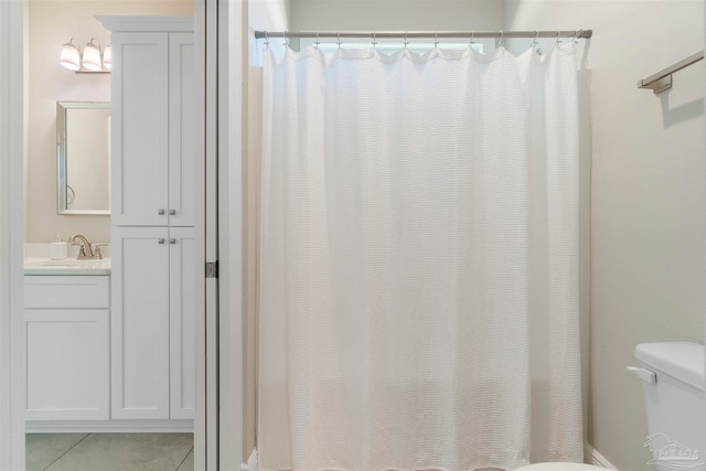 bathroom featuring vanity, toilet, curtained shower, and tile patterned floors