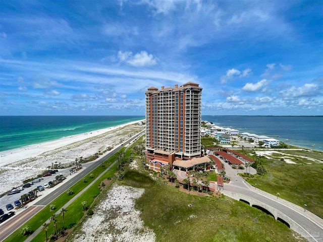 aerial view with a water view and a beach view