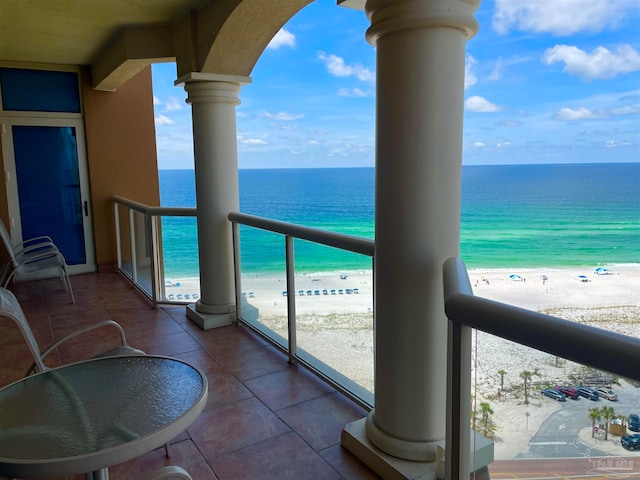 balcony with a water view and a beach view