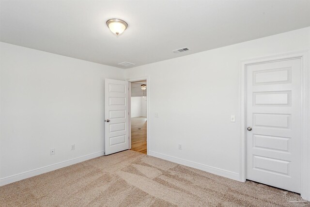 unfurnished room with light colored carpet