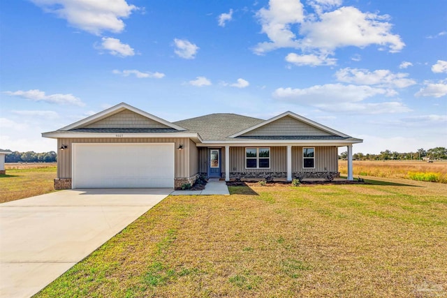 view of front of house featuring a garage and a front yard